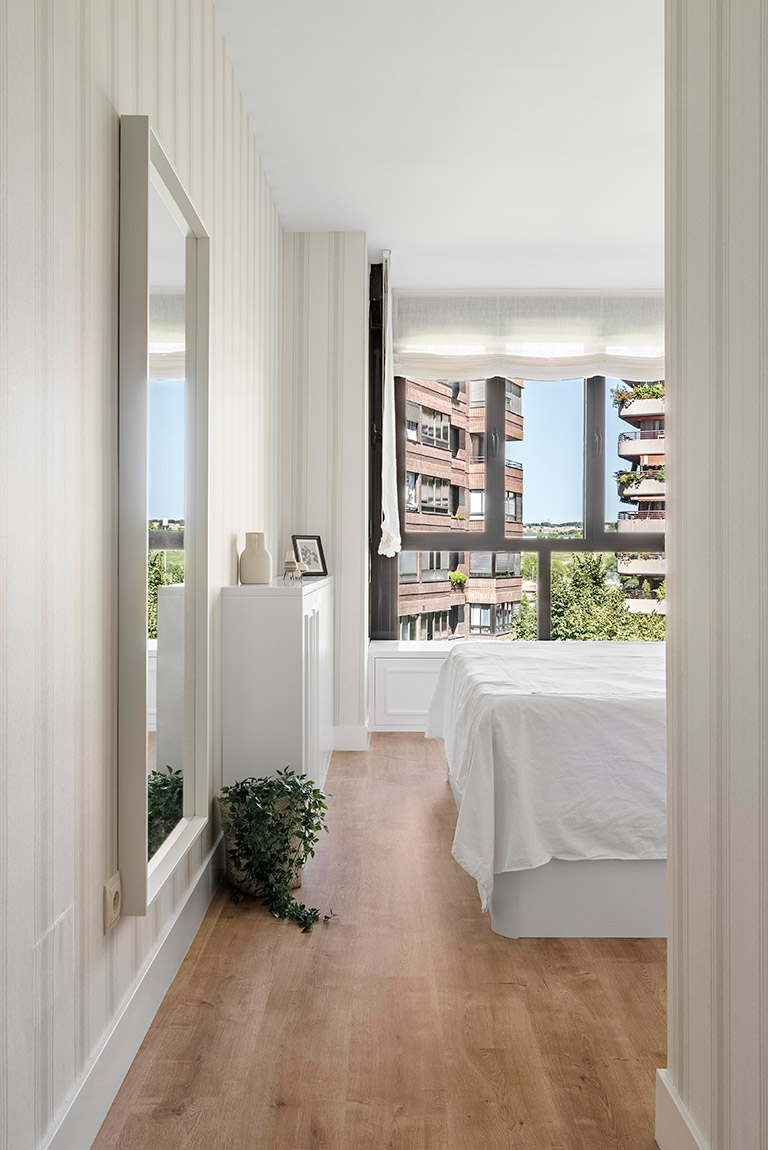 Entrada al dormitorio principal Carpintería a medida para dormitorio: cajonera, cómoda y espejo lacado blanco